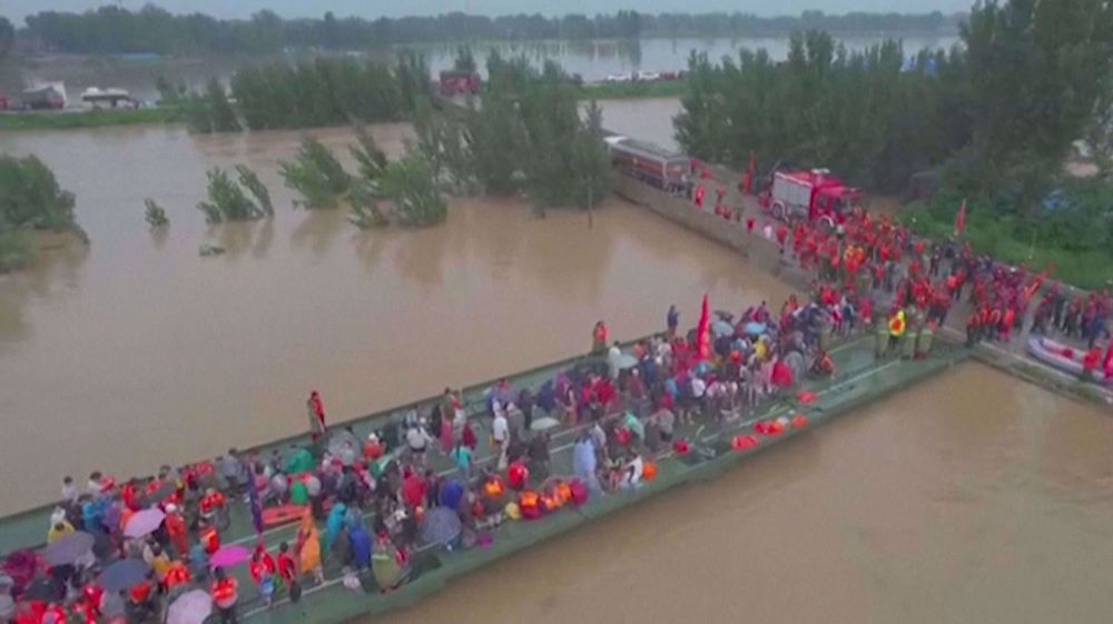 China evacuates flood-hit villagers with boat bridge  