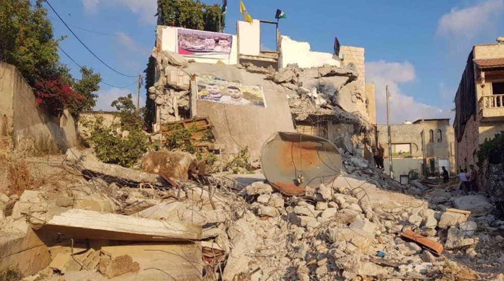 Israel demolishes homes of two Palestinian detainees, displacing 14 people