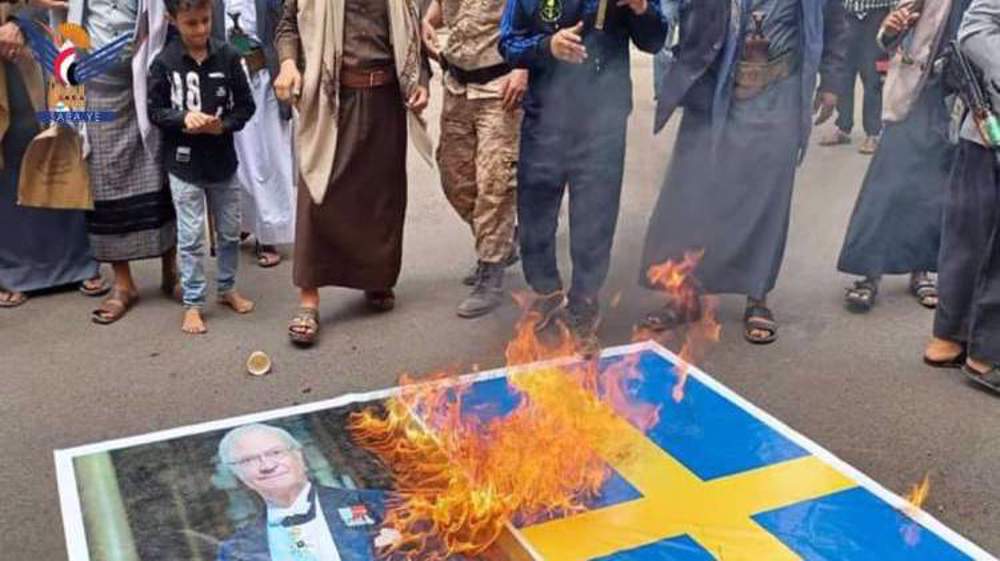 Yemeni protesters burn Swedish flag in Sana'a after Qur'an desecration 