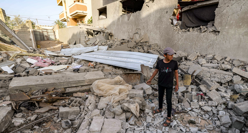 Palestinians inspect rubble of destroyed building in Rafah
