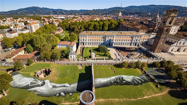 Drone flies over giant 'human chain', a street artist's global project calling for unity