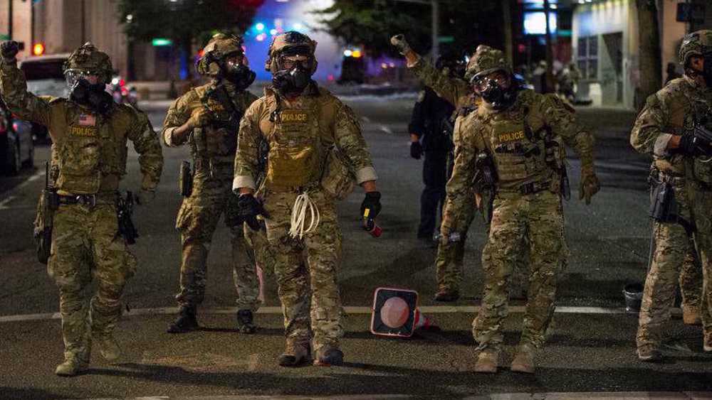 Who are masked, camouflaged men arresting protesters in Portland?