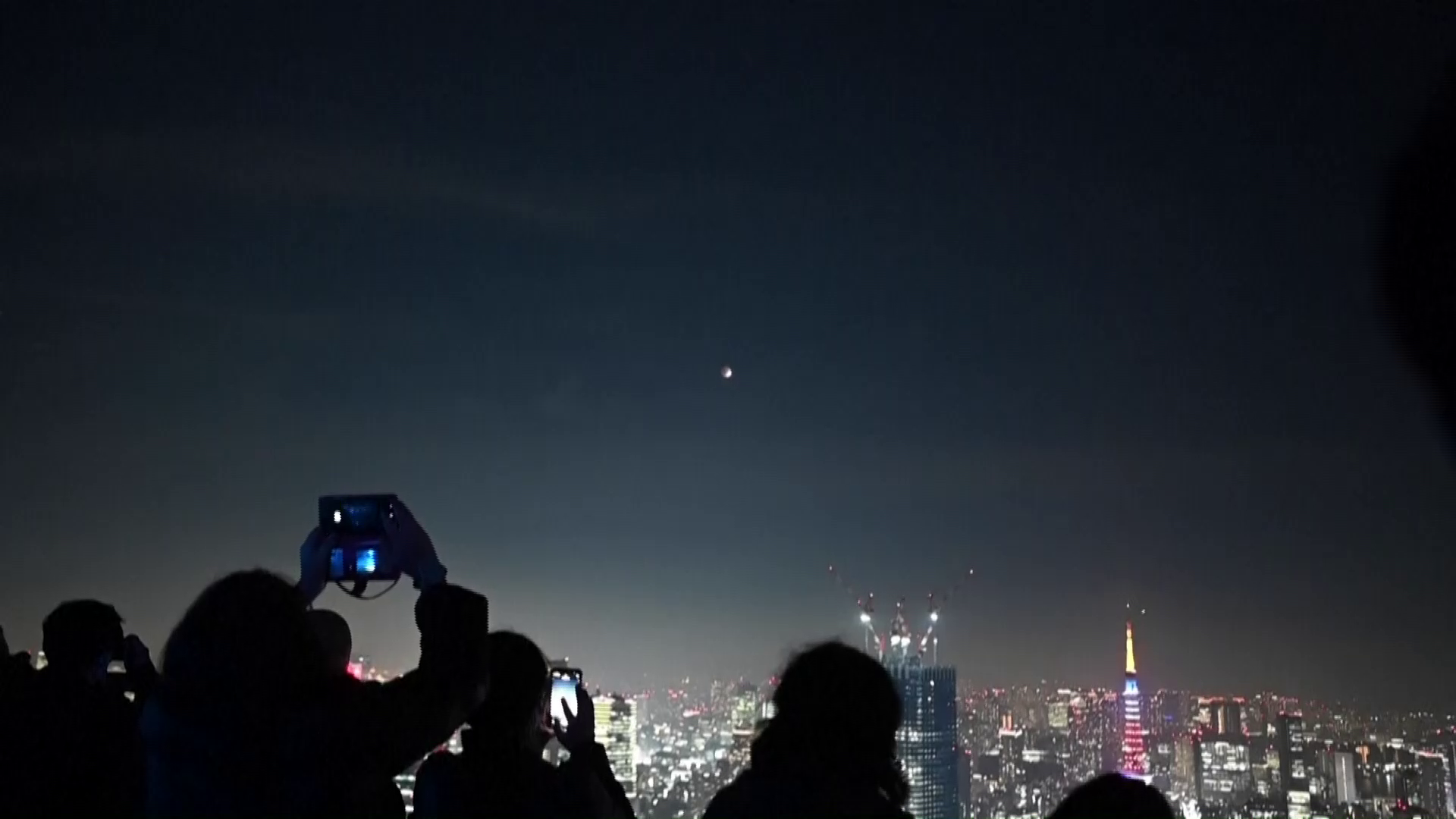 Tokyo residents watch partial lunar eclipse