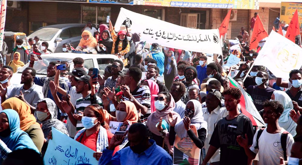 Sudan police fire tear gas at protesters as tens of thousands rally in capital for revolt anniversary