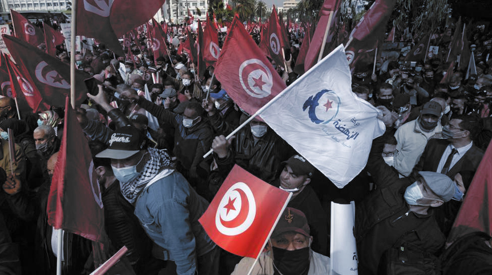 Tens of thousands march to support Tunisia’s largest political party