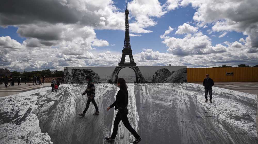French street artist creates Eiffel Tower optical illusion 