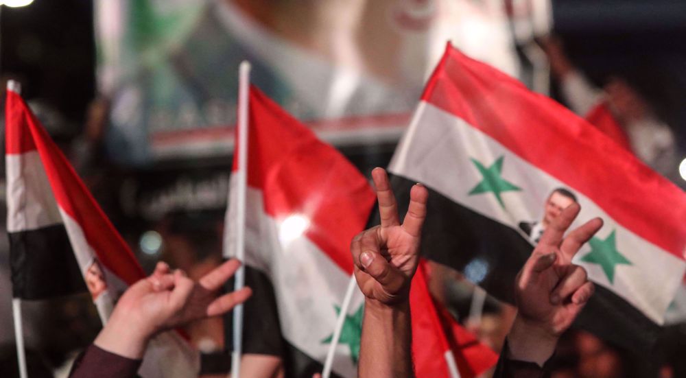 Syrians celebrate victory over opponents of election with high turnout  