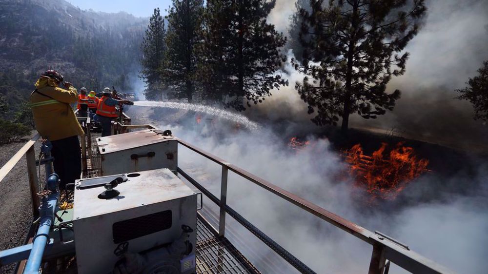 Hot, gusty winds fanning flames of massive US wildfires