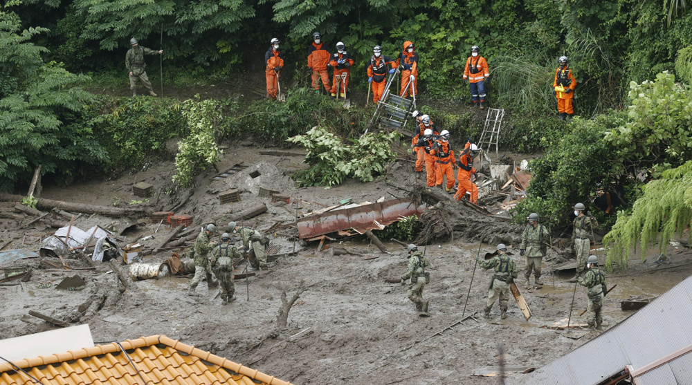 Japan rescue teams look for 20 missing in landslide