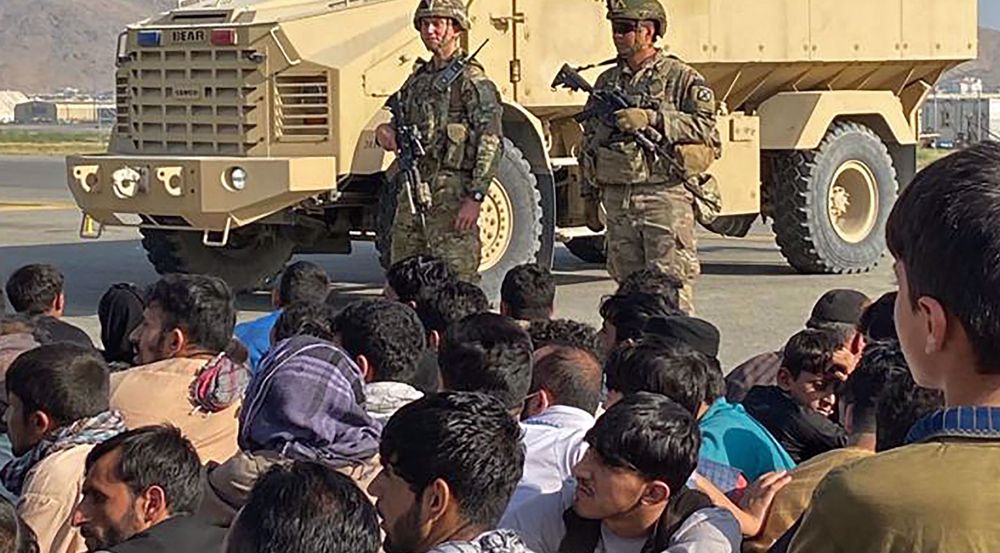 Chaos and killings at Kabul airport: US forces open fire as Afghans mob tarmac