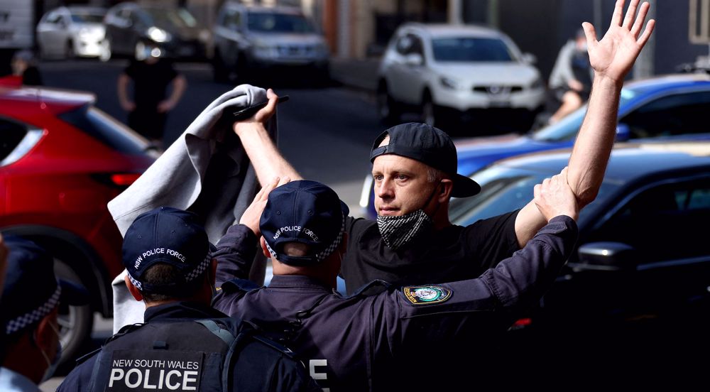 Police clash with protesters as Australia reports record COVID-19 cases