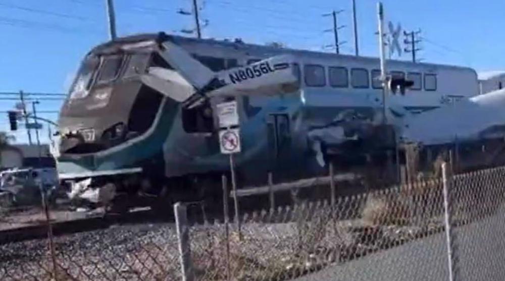MOMENT: Downed plane hit by train in Los Angeles just as pilot freed from wreckage