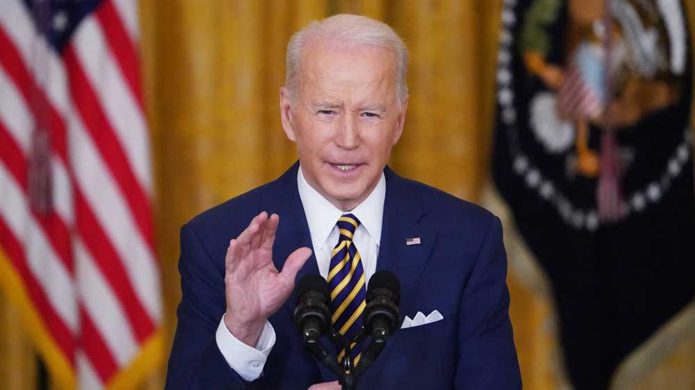 Biden defends first-year record as his agenda falters