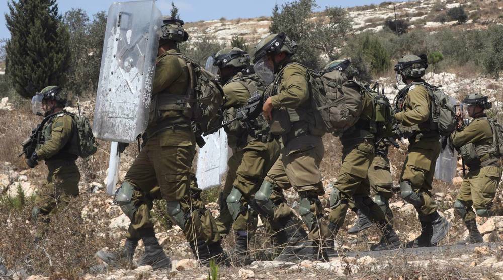 Israel forces put Palestinian camp, town under lockdown after shooting
