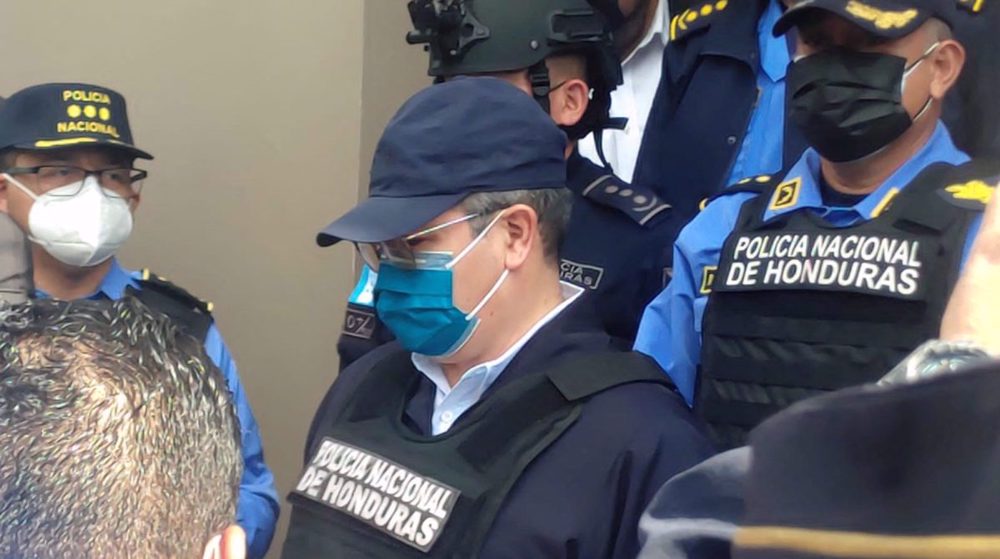 Handcuffed fmr. Honduran president escorted to police base