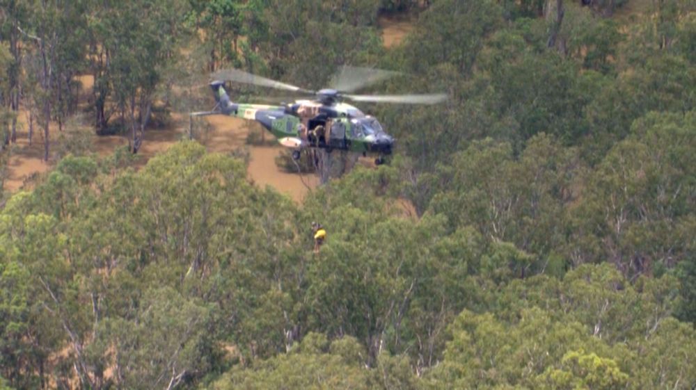 Helicopter crew rescues people trapped by floods in Australia