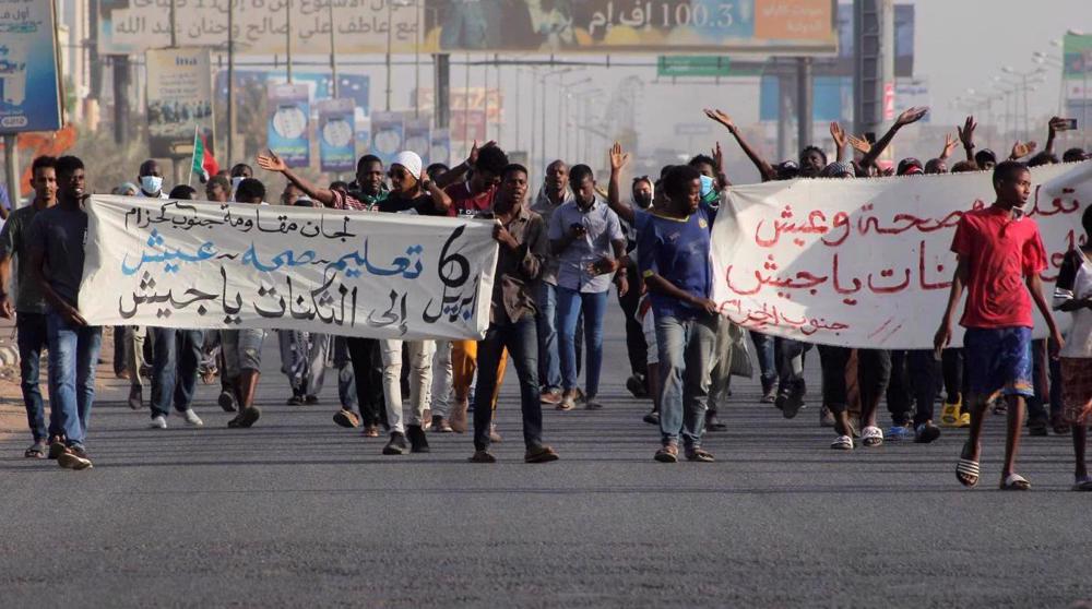 Sudan police fire tear gas as thousands rally 3 years after anti-Bashir uprising