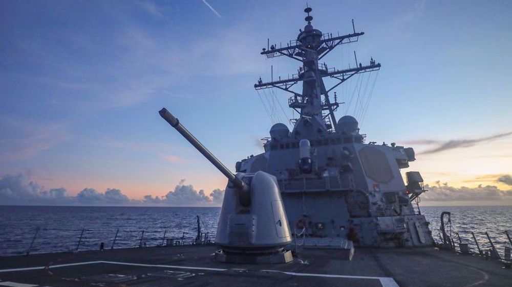 China warns away US warship near disputed isles in South China Sea