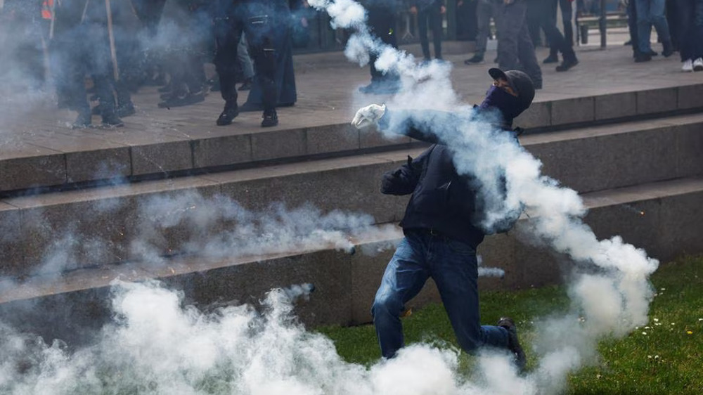 French police fire tear gas, clash with Labor Day protesters amid simmering anger over pension reform