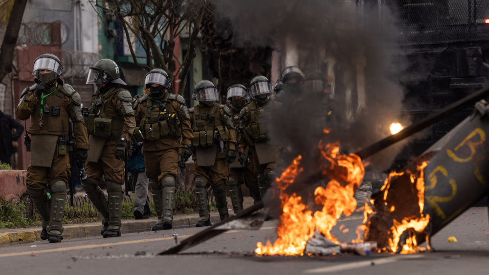 Clashes, arson mar Chile march to commemorate Pinochet victims