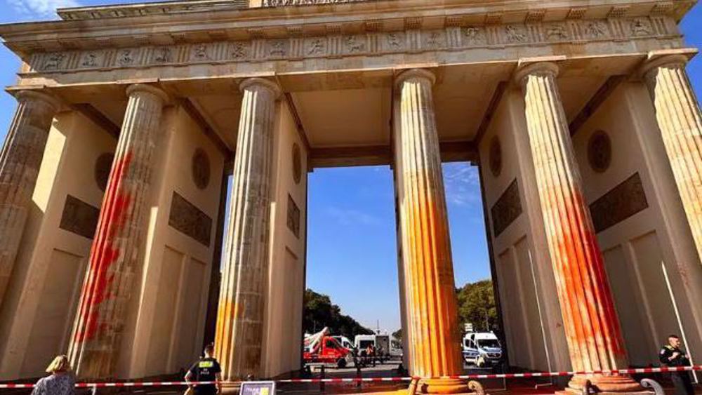 Climate activists spray Berlin's Brandenburg Gate orange