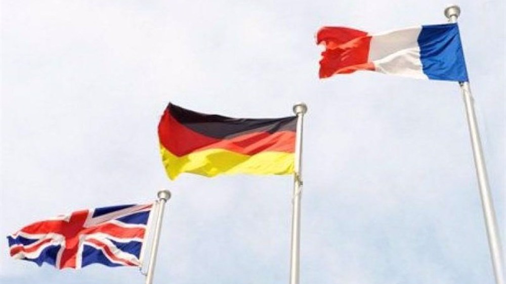 Photo shows flags of the United Kingdom (L), Germany and France.  