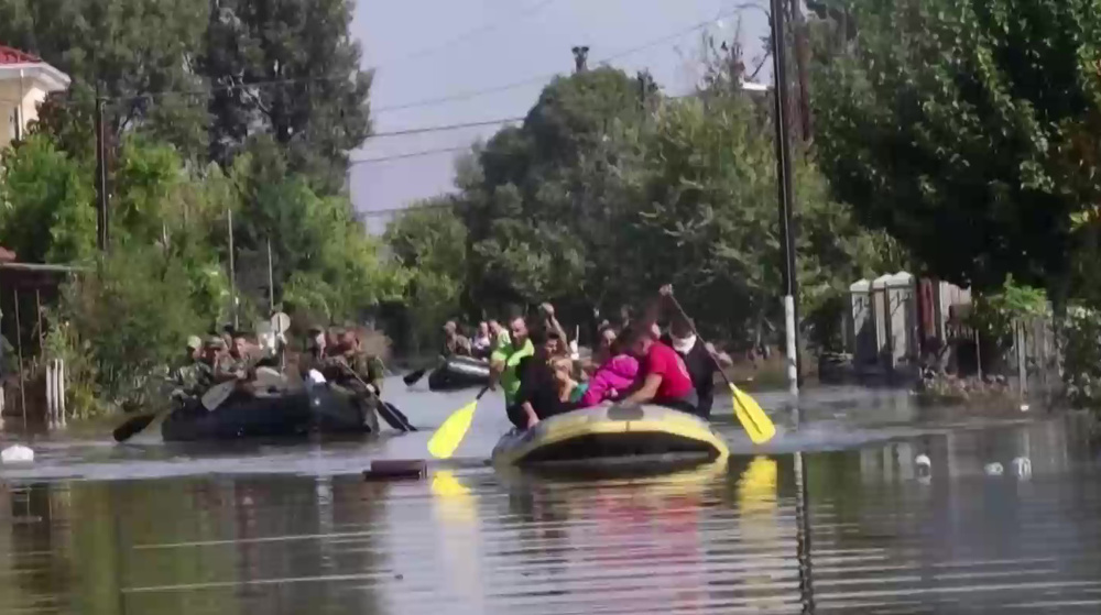 Soldiers evacuate locals on rubber boats from flooded Greek town