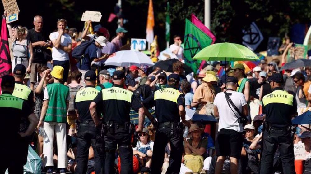 Dutch police use water cannon, detain 2,400 climate activists