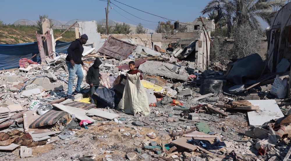 Palestinians inspect their destroyed homes in Gaza's Khan Yunis