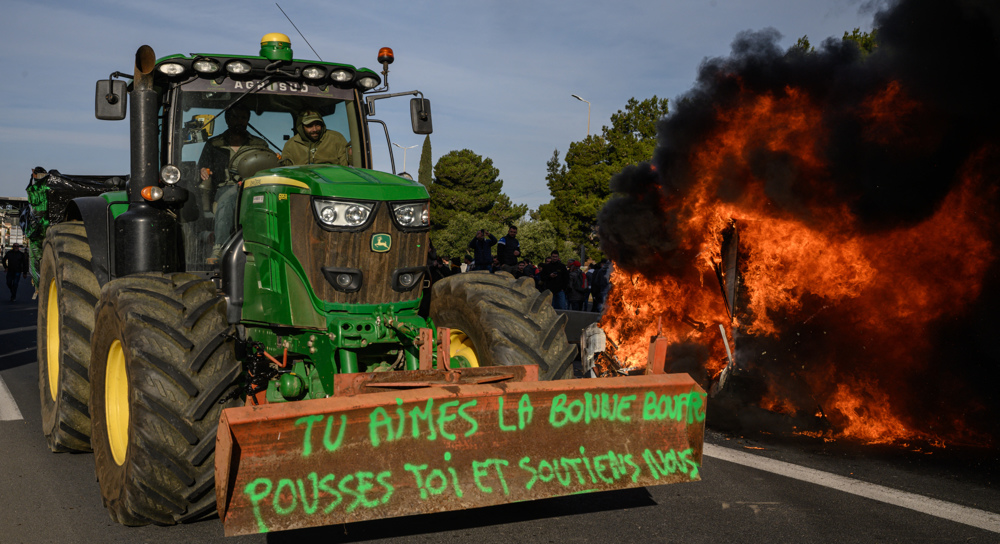 Angry French farmers stage fiery protest over plans to cut state subsidies