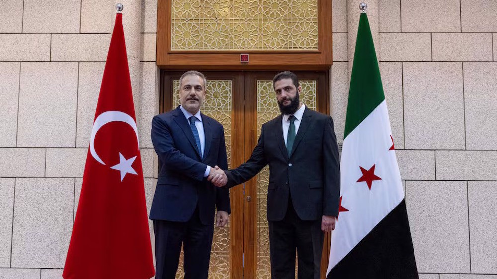 Turkey's foreign minister meets Syria's de facto leader in Damascus