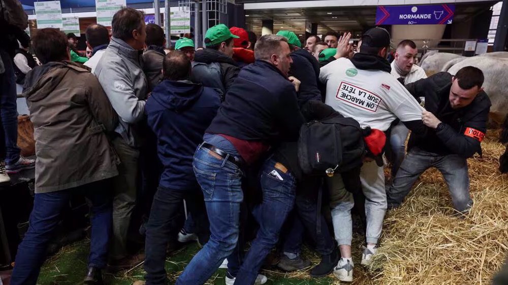 French farmers barge into agriculture fair in Paris in anger