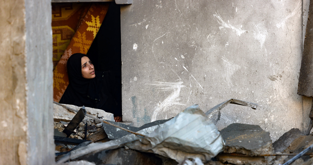 Displaced Palestinians take shelter in destroyed buildings amid Israeli strikes