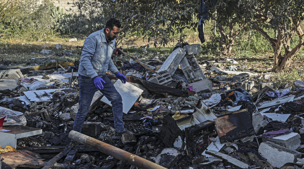 Gazans search through rubble following strike on house in Rafah