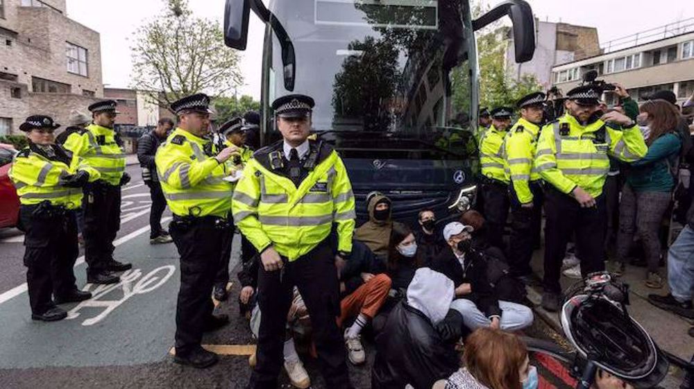 Protesters try to stop removal of migrants by UK police