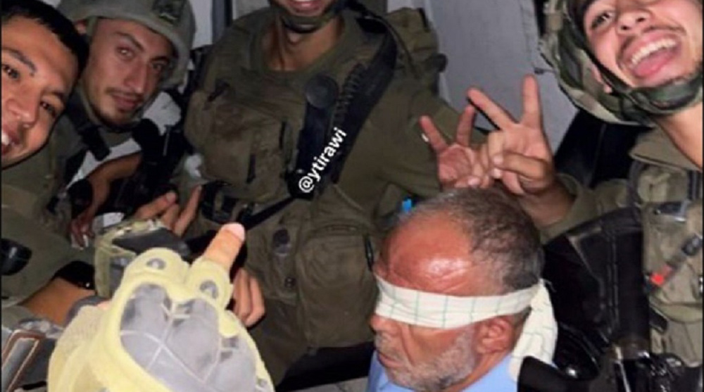 Israeli soldier releases photo of abusing elderly Palestinian abductee  