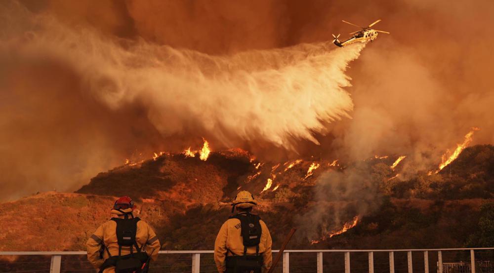 Los Angeles braces for strong winds threatening to intensify devouring wildfires