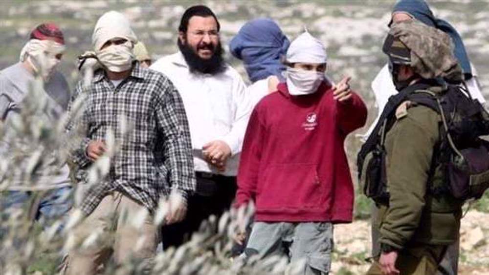 Armed Israeli settlers torch Palestinian land, assault civilians in occupied West Bank