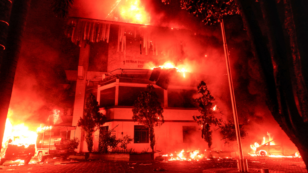 Three dead as Indonesian protesters set fire to regional parliament building