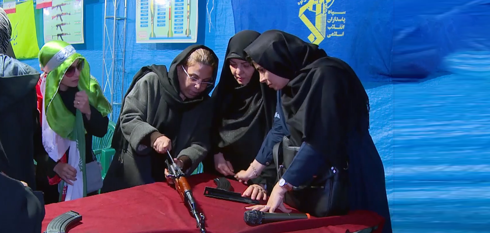 Iranian women, men train with kalashnikovs at nightly rallies