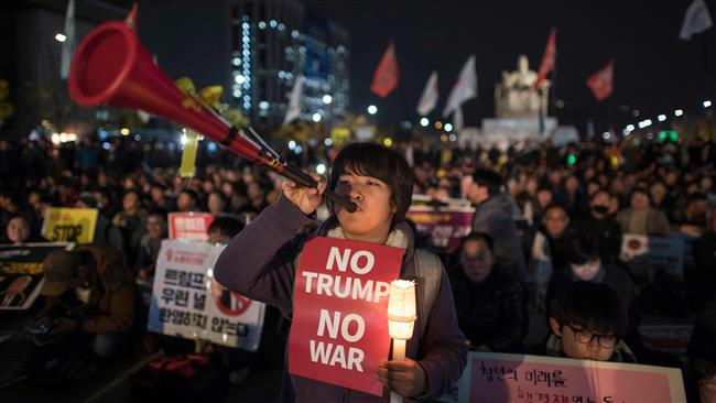 Trump visits S Korea amid opposing rallies
