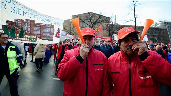 Angry Siemens workers protest job cuts in Germany