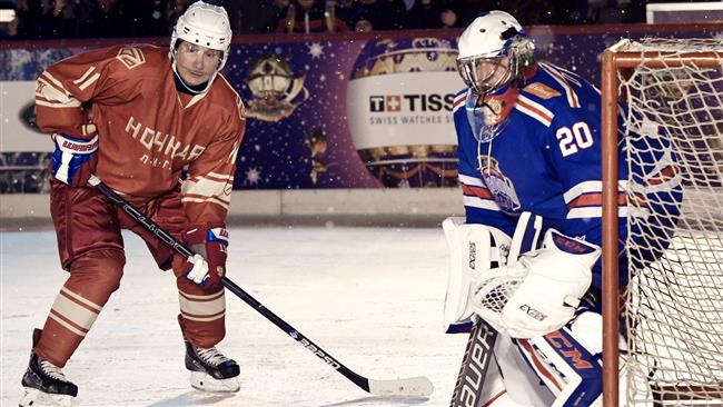 Putin plays hockey alongside defense minister