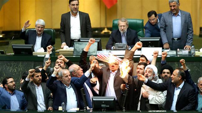 US flag up in flames inside Iranian parliament 