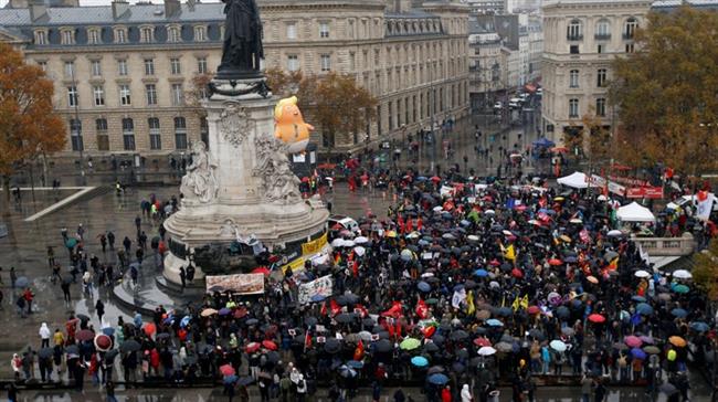 Trump baby blimp joins thousands at Paris protests