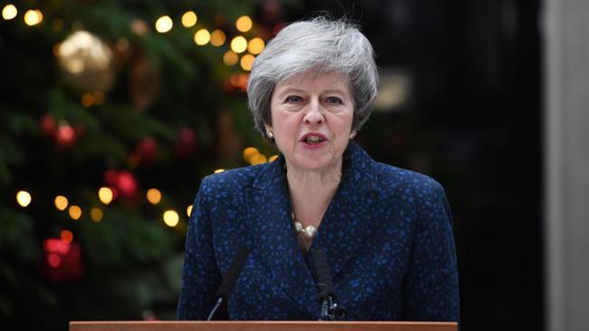 May vows to fight challenge to her leadership