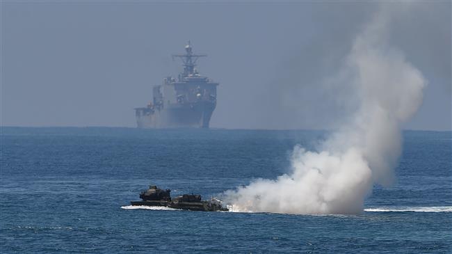 China military warns off US warship in disputed sea