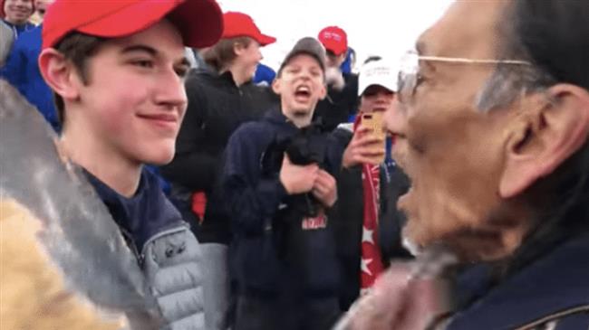 Students in Trump hats taunt Native American marchers