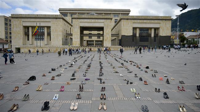 Venezuelans in Colombia display shoes against xenophobia