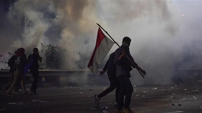 Indonesia police arrest hundreds as protests turn violent